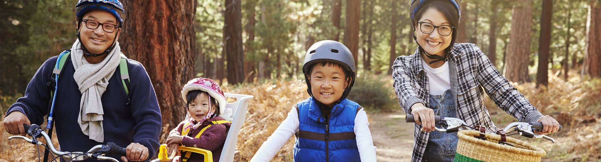 family riding bikes on a trail