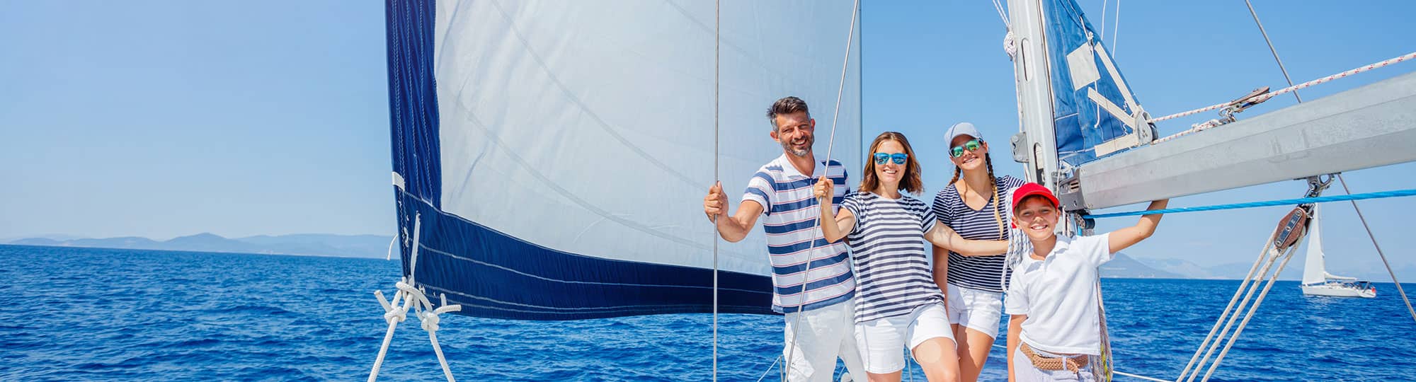 a family on a sailboat on the ocean